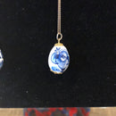 Blue ceramic egg on gold chain