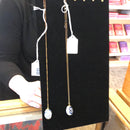 Blue ceramic egg on gold chain